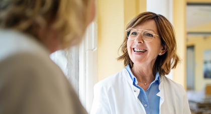 An AHN provider smiling as she talks to her patient.