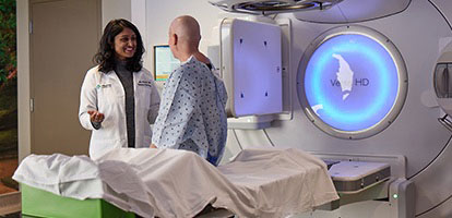 AHN cancer institute specialist talking to patient before a cancer treatment.
