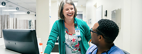 image of a nurse talking to her colleague
