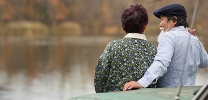 outdoor photo of a senior couple  having a conversation by a lake
