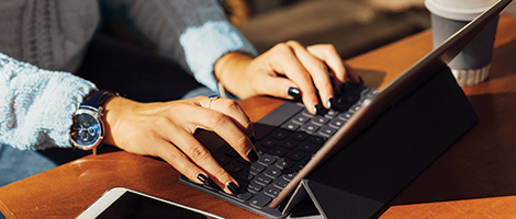 Hands typing on a laptop