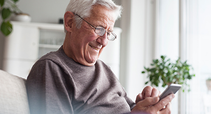 An elderly man scheduling an appointment on a mobile phone device.