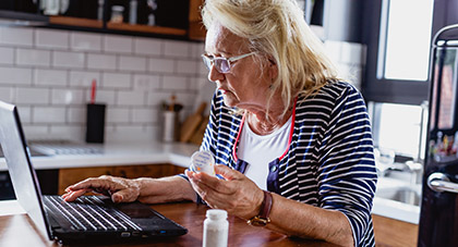 elderly woman using her laptop to request a prescription refill on MyChart
