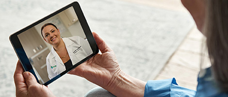 An older woman using her tablet for her video visit with her doctor.