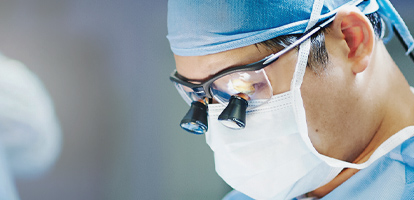 A surgeon performing a procedure in an operating room (OR).