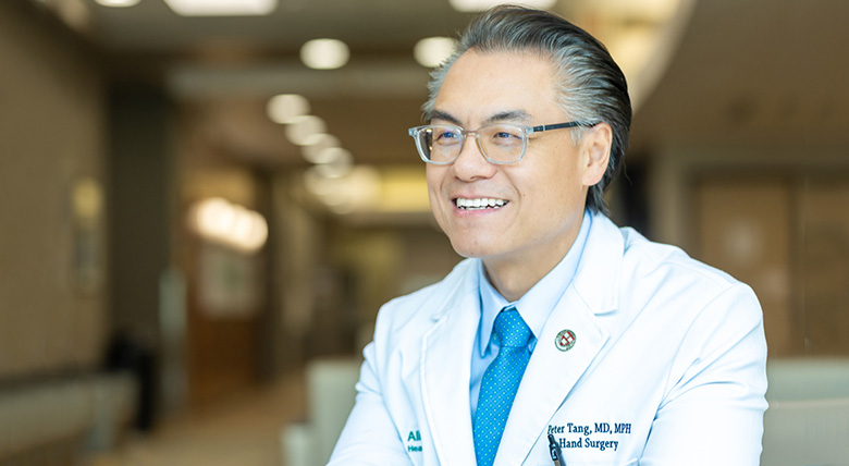 Dr. Peter Tang, in his white coat, is a friendly face at the nerve and brachial plexus injury center.