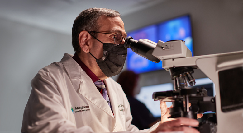 Image of doctor using microscope