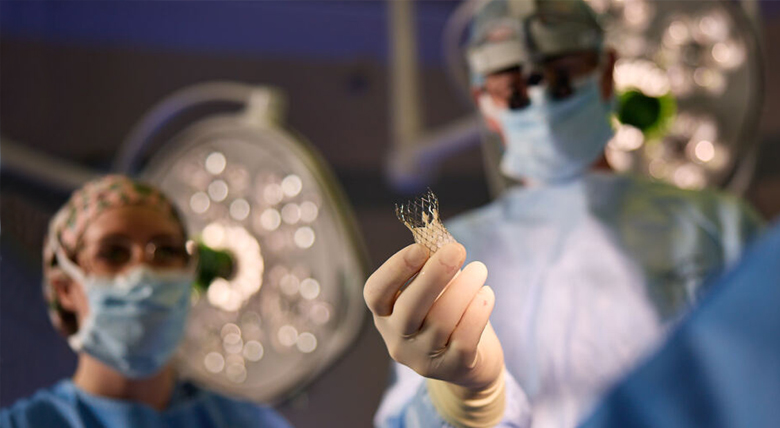Image of doctor holding TAVR device