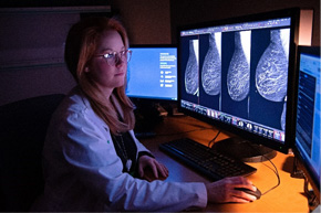 Medical professional looking at breast scans
