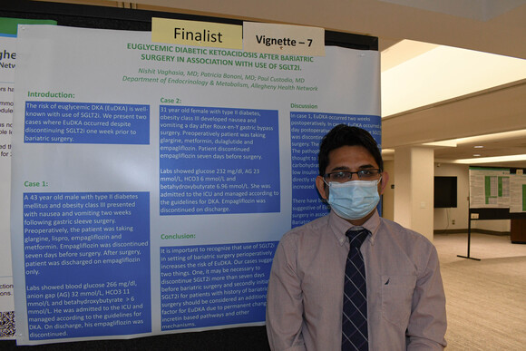 An AHN fellow who is a finalist standing by his vignette.