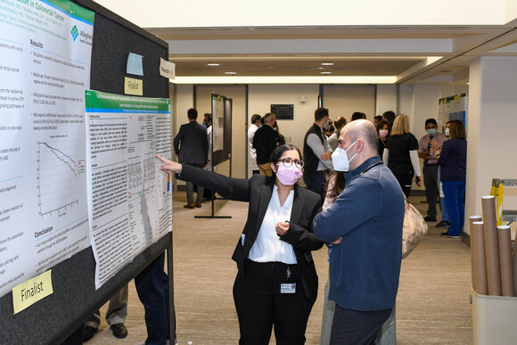 AHN fellow explains her research to one of the judges.