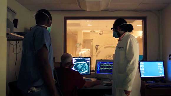 Hematology-oncology fellows observe an MRI in progress.