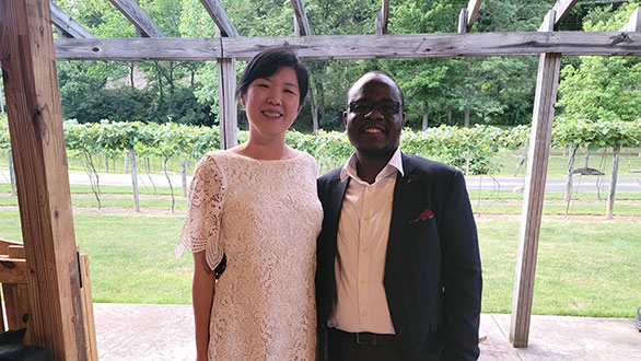 2020-2021 graduates Jean Woo, MD and Osakpolor Ogbebor, MD standing on a patio in a vineyard.