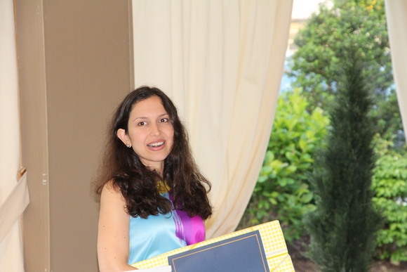 2014-2015 graduate Raquel Ramos, MD holding a diploma.