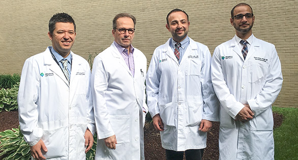 image of 4 interventional cardiology graduates class of 2018 smiling outside of allegheny general hospital