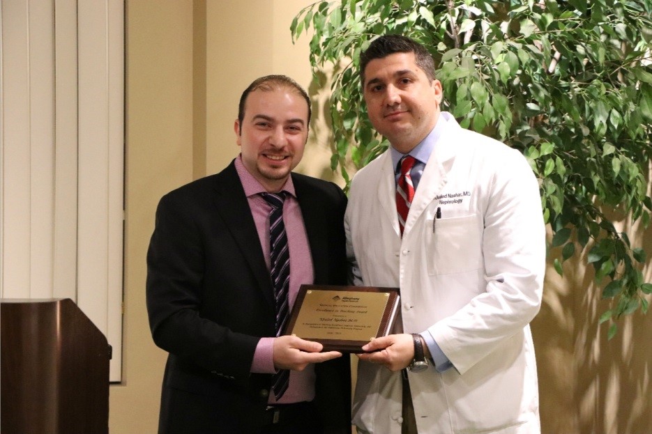 Nephrology fellow and doctor holding a plaque