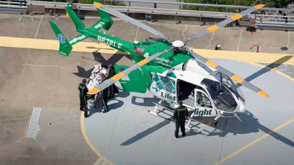 Drone shot of emergency medicine residents transporting a patient off an AHN life flight helicopter.