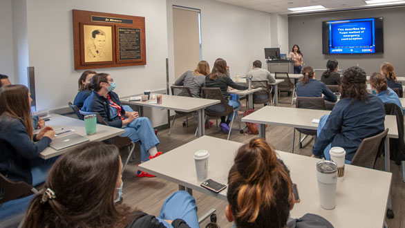 A shot of residents in a classroom listening to a lecture.