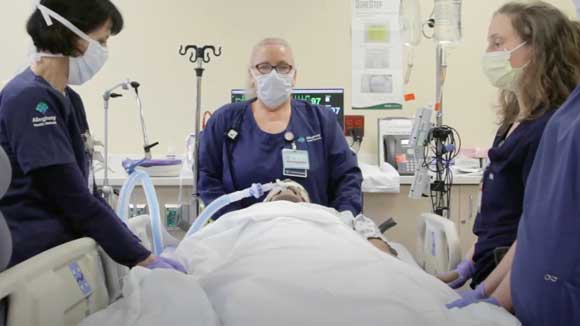 Four nurses prepare to practice moving a ventilated patient from supine to prone position