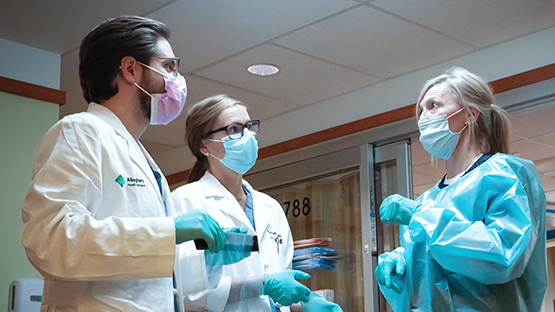 AHN physicians wearing masks consulting on rounds.