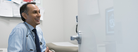 A doctor talking to a patient in an examination room