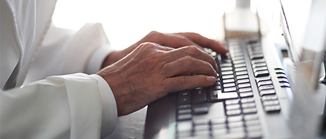  closeup of a set of hands typing on a computer keyboard