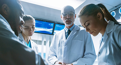group of doctors in an exam room working