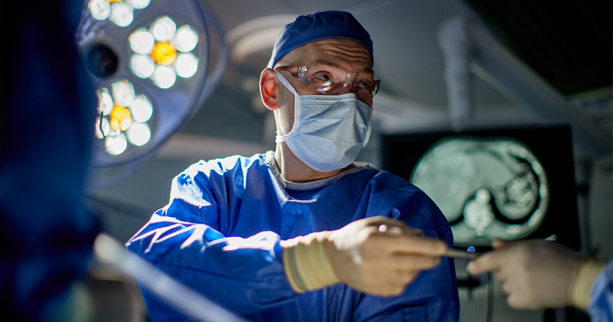 Surgeon showing anatomy image on screen