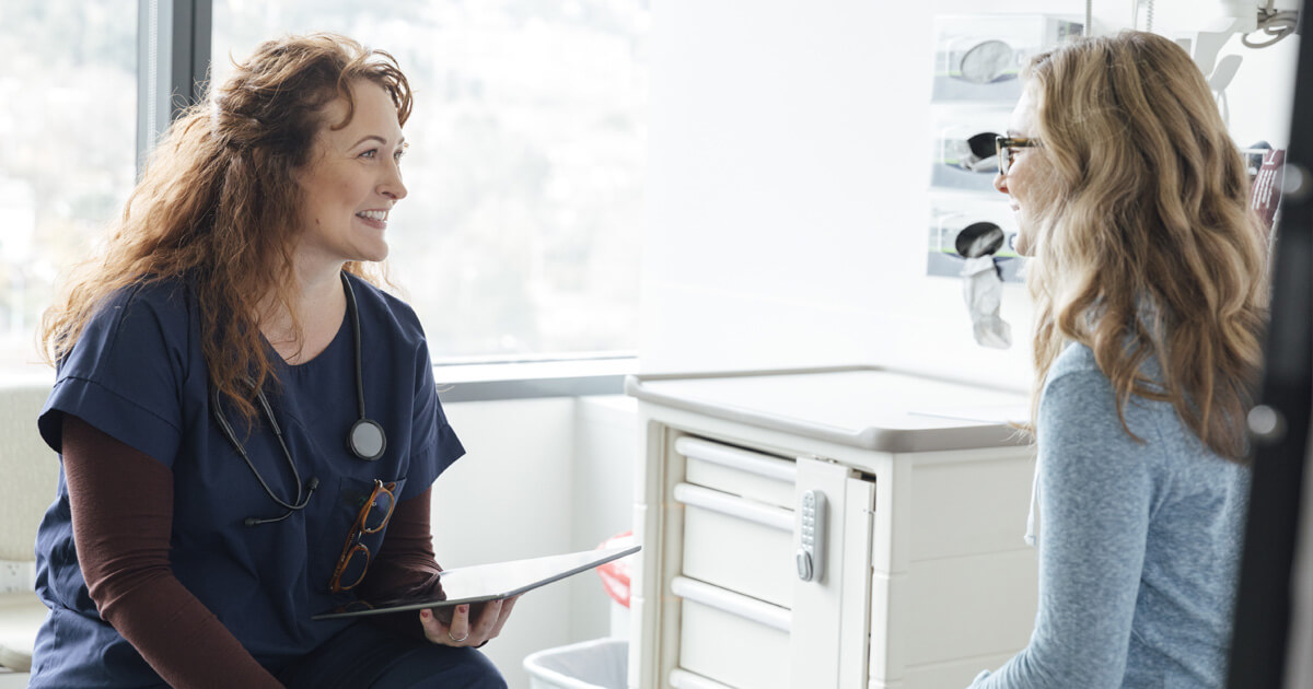 Woman talking with doctor