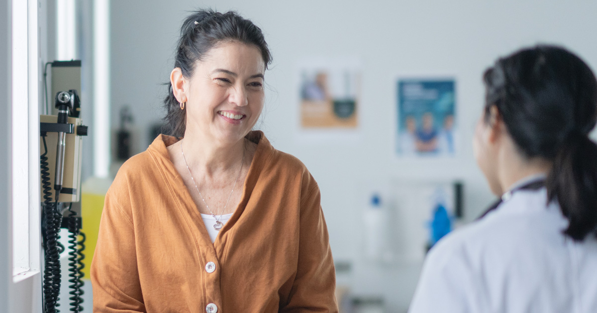 Woman sitting on exam table at doctor's office
