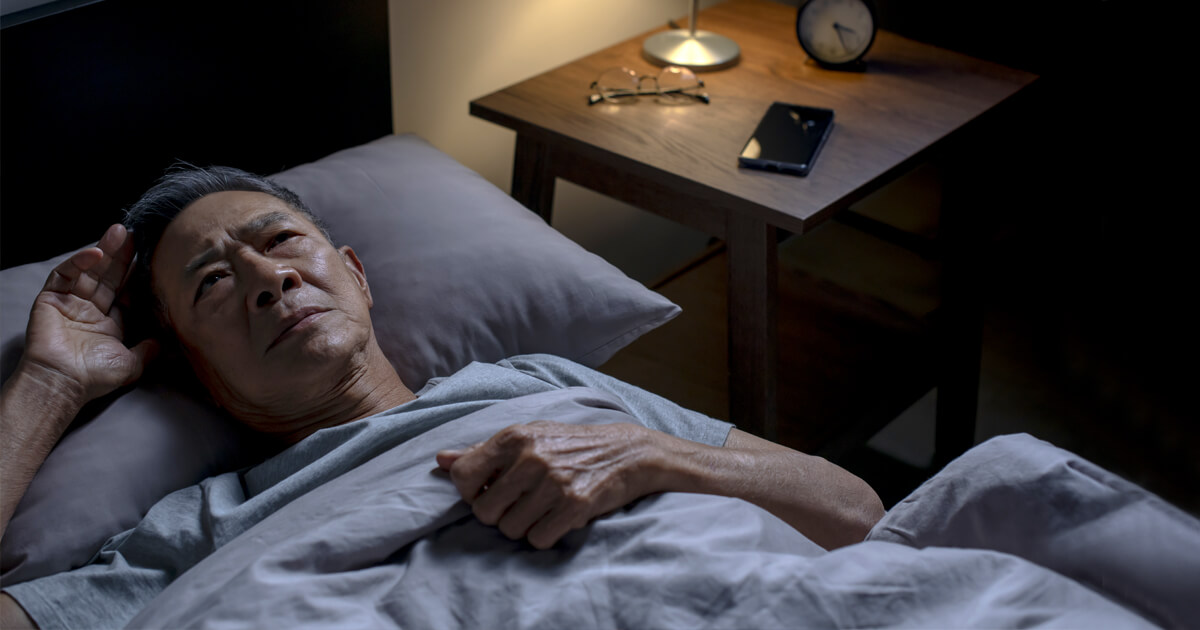 Man lying awake in bed