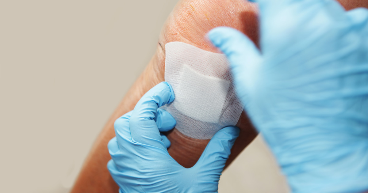 Person getting a bandage on their leg