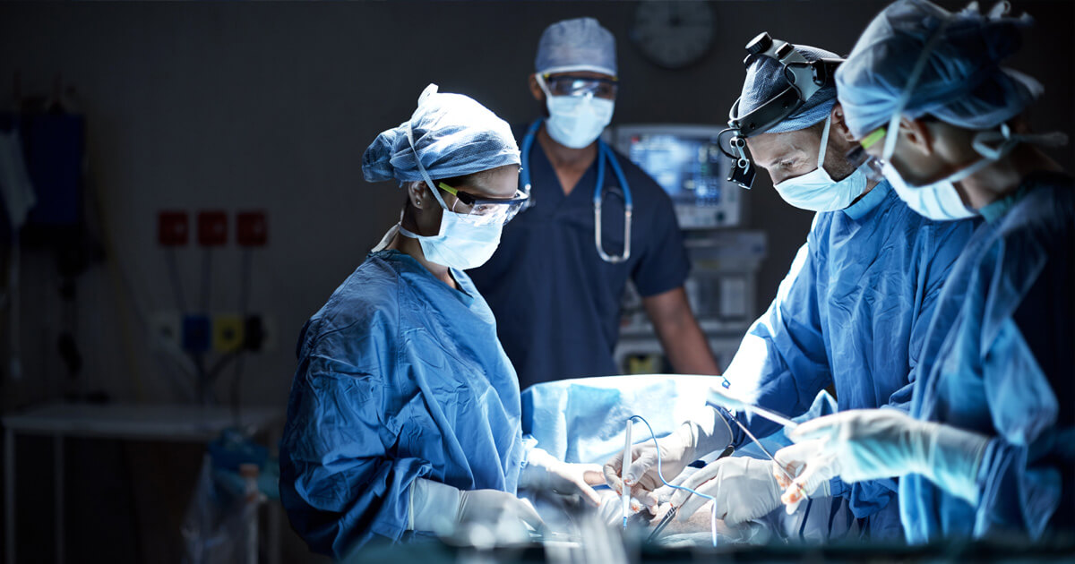 Group of surgeons at operating table