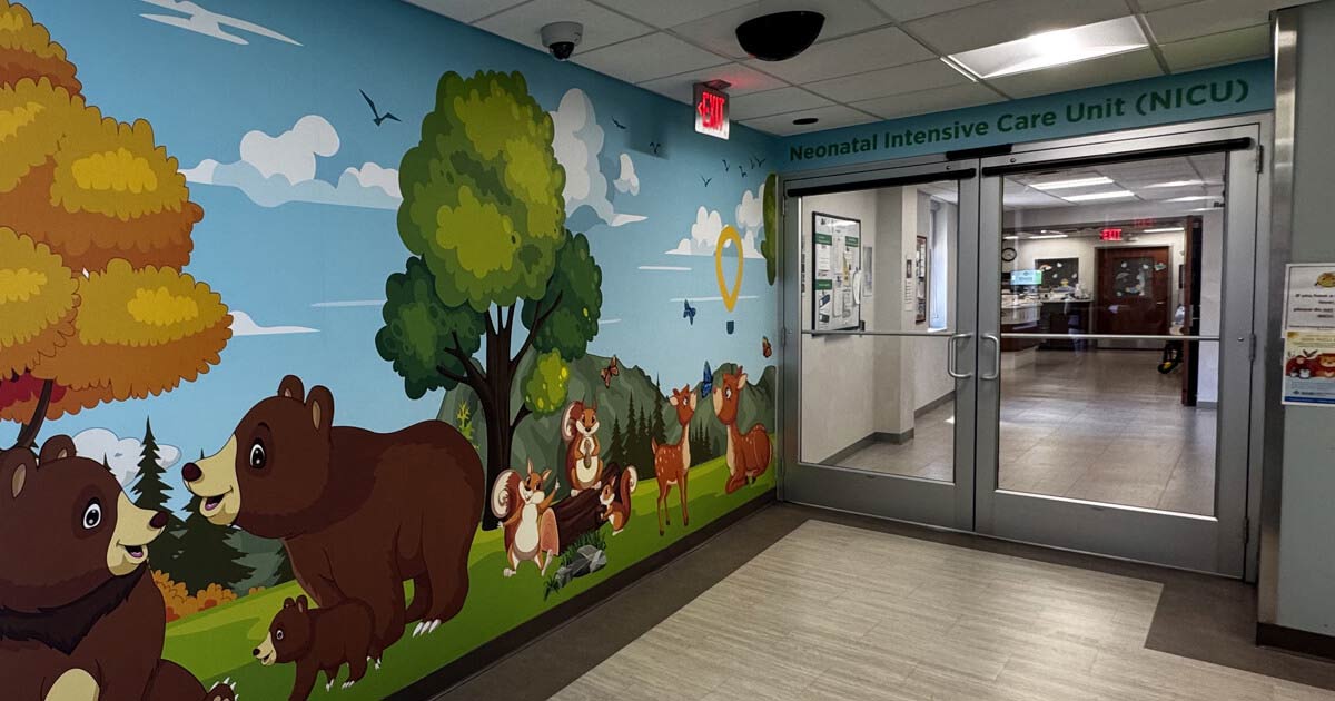 Colorful wall murals adorn the entrance to the NICU at AHN Saint Vincent Hospital, creating a comforting environment.