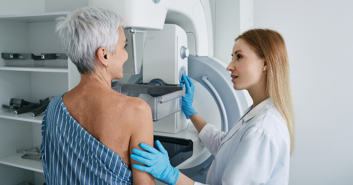 Patient with nurse at mammogram machine