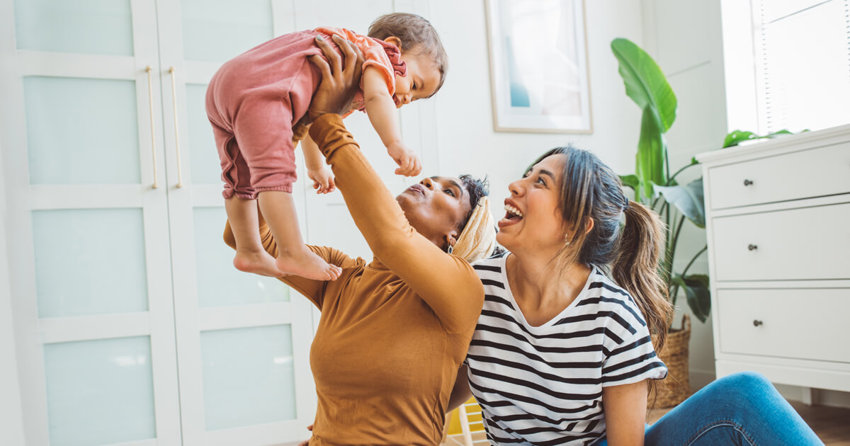 Couple holding baby up in the air
