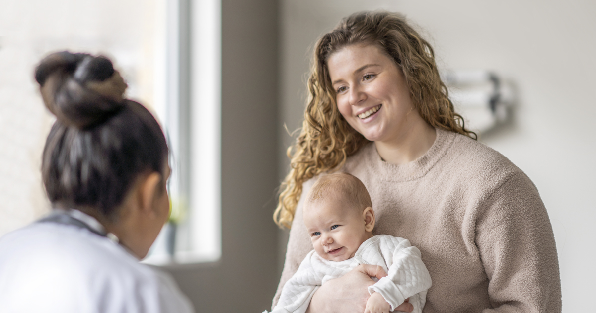 Woman holding her baby at a doctor visit