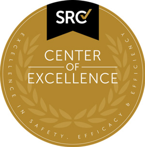 A gold circular badge with "CENTER OF EXCELLENCE" in the middle and "SRC" at the top.