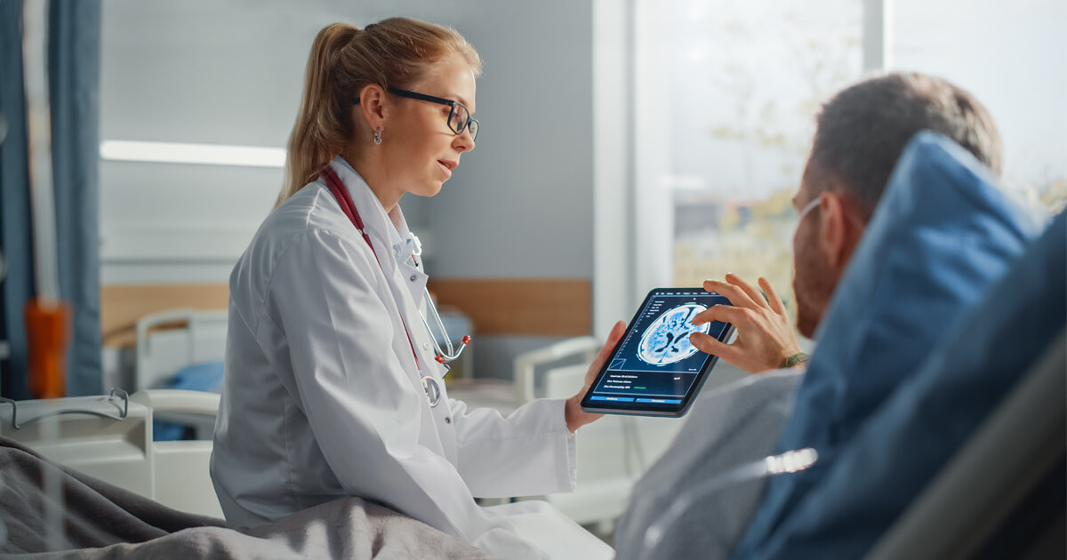 Patient and doctor looking at brain scan image