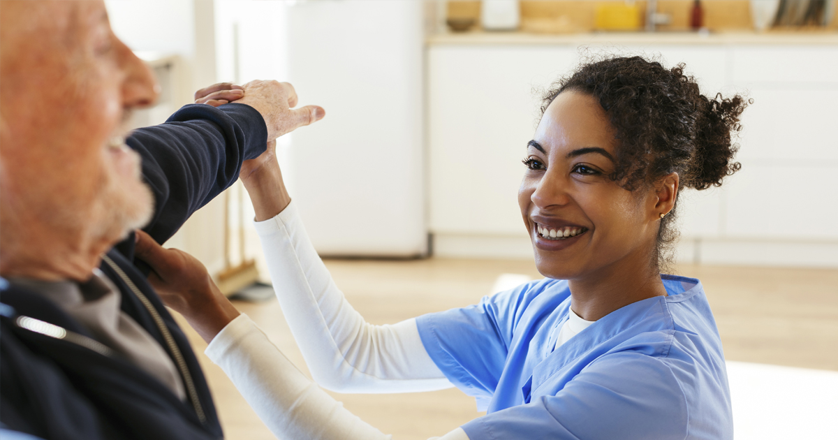 Male patient working with nurse on arm stretch.