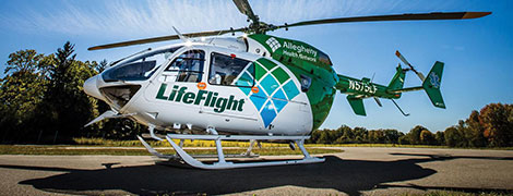 AHN LifeFlight helicopter on the helipad under sunny skies