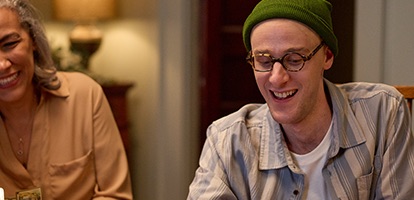 photo of a man and women having fun playing a card game