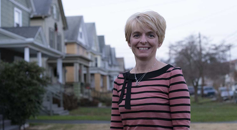 AHN heart re-transplant patient standing outside her house in her neighborhood