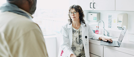 female doctor in exam room listening to patient