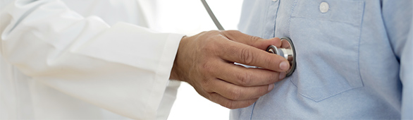 AHN physician listening to patient’s heart using a stethoscope.