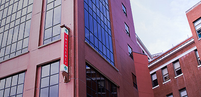 A view of the exterior of West Penn Hospital and its Emergency sign, which is attached to it.