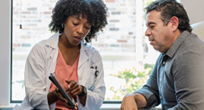 A physician illustrating something on a tablet.