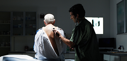 image of physician listening to patients lungs 