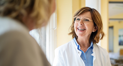 An AHN provider smiling as she talks to her patient.