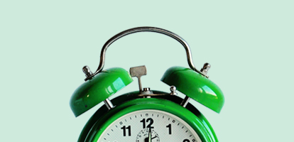 green alarm clock about to ring
